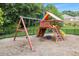 Community playground features a slide, swings, a climbing wall, and seating area with a tire swing at 4815 Edgemoore Trce, Cumming, GA 30040