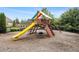 Community playground with a slide, tire swing, and climbing wall, all enclosed by a black fence at 4815 Edgemoore Trce, Cumming, GA 30040