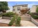 The back exterior of this home has a deck and a backyard that has a retaining wall at 5312 Tormeal Trce, Suwanee, GA 30024