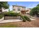 Back exterior of home has a deck, and a backyard that has a retaining wall and mature shrubs at 5312 Tormeal Trce, Suwanee, GA 30024
