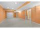 Spacious basement with neutral carpet, lighting, white trim, and peach-colored walls at 5312 Tormeal Trce, Suwanee, GA 30024