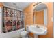 Small full bathroom with a tub and shower has peach-colored walls, a white toilet, and vanity at 5312 Tormeal Trce, Suwanee, GA 30024