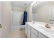 Bright bathroom features a double vanity, tile flooring, and a shower-tub combination at 5312 Tormeal Trce, Suwanee, GA 30024