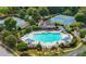 Aerial view of a community pool surrounded by lounge chairs and shaded areas, with tennis courts nearby at 5312 Tormeal Trce, Suwanee, GA 30024