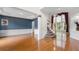 Inviting entryway featuring hardwood floors, elegant wainscoting, and a staircase with carpeted steps at 5312 Tormeal Trce, Suwanee, GA 30024