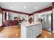 Eat-in kitchen features hardwood floors, white cabinets, stainless appliances, and island at 5312 Tormeal Trce, Suwanee, GA 30024
