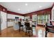 Bright eat-in kitchen boasts white cabinets, stainless appliances, hardwood floors, and center island with seating at 5312 Tormeal Trce, Suwanee, GA 30024