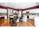 Bright eat-in kitchen boasts white cabinets, stainless appliances, hardwood floors, and center island with seating at 5312 Tormeal Trce, Suwanee, GA 30024