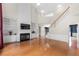 Open-concept living room featuring a fireplace, built-in shelves, and hardwood flooring at 5312 Tormeal Trce, Suwanee, GA 30024