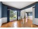 Spacious living area with hardwood floors, wainscoting, and large windows providing ample natural light at 5312 Tormeal Trce, Suwanee, GA 30024