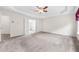 Spacious main bedroom offers neutral paint, plush carpet, and ensuite bathroom with double doors at 5312 Tormeal Trce, Suwanee, GA 30024
