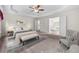 Spacious main bedroom boasts tray ceiling, plush carpet floors, and ensuite bathroom with double doors at 5312 Tormeal Trce, Suwanee, GA 30024