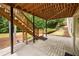 Patio area under deck stairs has concrete flooring and access to backyard, under the deck at 5312 Tormeal Trce, Suwanee, GA 30024