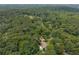 A high aerial of the backyard of this home showcasing the mature trees and landscaping at 5401 Rosser Rd, Tucker, GA 30087