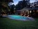Beautiful backyard featuring a sparkling pool and inviting patio with a covered outdoor entertaining space at 5401 Rosser Rd, Tucker, GA 30087