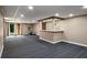 Finished basement with bar area, neutral colored walls, carpet flooring, and potential for entertainment at 5401 Rosser Rd, Tucker, GA 30087