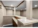 This basement bar area features a two-tiered countertop, wood paneling, and recessed lighting at 5401 Rosser Rd, Tucker, GA 30087