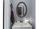 Cozy bathroom featuring a single sink vanity, decorative mirror, and neutral decor at 5401 Rosser Rd, Tucker, GA 30087