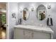 Bathroom with double vanity sinks, marble countertops, with decorative lighting, and neutral walls at 5401 Rosser Rd, Tucker, GA 30087