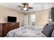 Bedroom showcases natural light, a ceiling fan, dresser, and cozy decor with access to the bathroom at 5401 Rosser Rd, Tucker, GA 30087