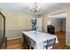 Formal dining room featuring classic wallpaper, wainscoting, and view of another room at 5401 Rosser Rd, Tucker, GA 30087