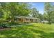 Attractive brick home with a well-maintained lawn, mature trees, and landscaped garden beds at 5401 Rosser Rd, Tucker, GA 30087