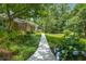 Landscaped pathway leading to a charming brick home with a covered porch and well-maintained yard at 5401 Rosser Rd, Tucker, GA 30087