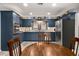 Kitchen with stainless appliances, a wooden table and blue cabinets at 5401 Rosser Rd, Tucker, GA 30087