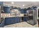 Bright kitchen with stainless steel appliances, blue cabinets, and light countertops at 5401 Rosser Rd, Tucker, GA 30087