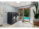 Laundry room with modern washer and dryer, tile floors, and direct access to the pool area at 5401 Rosser Rd, Tucker, GA 30087