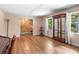 Open living room features hardwood floors, large windows, and a view of the porch at 5401 Rosser Rd, Tucker, GA 30087