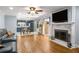 Open-concept living room with hardwood floors, fireplace, and access to the courtyard and kitchen at 5401 Rosser Rd, Tucker, GA 30087