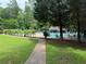 Community pool is fenced with lounge chairs and umbrellas at 5401 Rosser Rd, Tucker, GA 30087