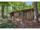 A shed nestled among trees in the back yard of the property at 5401 Rosser Rd, Tucker, GA 30087