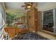 Sunroom showcasing wicker furniture, brick accent wall, and a ceiling fan, ideal for relaxation at 5401 Rosser Rd, Tucker, GA 30087