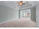 Main bedroom with a tray ceiling, fan, light green walls and carpet at 611 Parkside Village Nw Way, Marietta, GA 30060