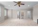 Large, airy bedroom featuring multiple doorways, carpet flooring, and a ceiling fan at 611 Parkside Village Nw Way, Marietta, GA 30060