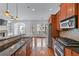 Open kitchen with wood cabinets, granite countertops, stainless steel appliances and hardwood floors at 611 Parkside Village Nw Way, Marietta, GA 30060