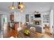 Inviting living room with a fireplace, built-in bookshelves, hardwood floors, and an open kitchen view at 611 Parkside Village Nw Way, Marietta, GA 30060
