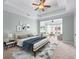 Bright main bedroom with a sitting area, featuring a tray ceiling, neutral walls, and stylish decor at 611 Parkside Village Nw Way, Marietta, GA 30060