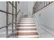 Elegant staircase featuring wood steps and trim, complemented by white walls and wrought iron details at 611 Parkside Village Nw Way, Marietta, GA 30060
