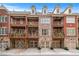 Beautiful brick and stone townhomes featuring private garages and outdoor balconies on multiple levels at 611 Parkside Village Nw Way, Marietta, GA 30060