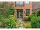 Charming backyard with stone walkway, lush greenery, and brick building at 1220 State Nw St, Atlanta, GA 30318