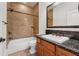 Bathroom with a granite-topped vanity, a bathtub and shower and a built-in shelf at 1220 State Nw St, Atlanta, GA 30318