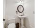Classic bathroom with a pedestal sink, oval mirror, and white toilet at 1220 State Nw St, Atlanta, GA 30318