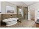 Bright bathroom featuring a soaking tub, glass shower, and tiled floor at 1220 State Nw St, Atlanta, GA 30318