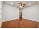 Hardwood floored bedroom showing neutral walls, a ceiling fan and a staircase in the background at 1220 State Nw St, Atlanta, GA 30318