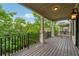 Inviting outdoor deck with black iron railing, wooden floor, and green neighborhood views at 1220 State Nw St, Atlanta, GA 30318