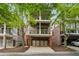 A two-story home with three outdoor decks, brick accents, and an attached garage at 1220 State Nw St, Atlanta, GA 30318