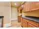 A spacious kitchen with granite countertops, wooden cabinets, and tile flooring at 1220 State Nw St, Atlanta, GA 30318